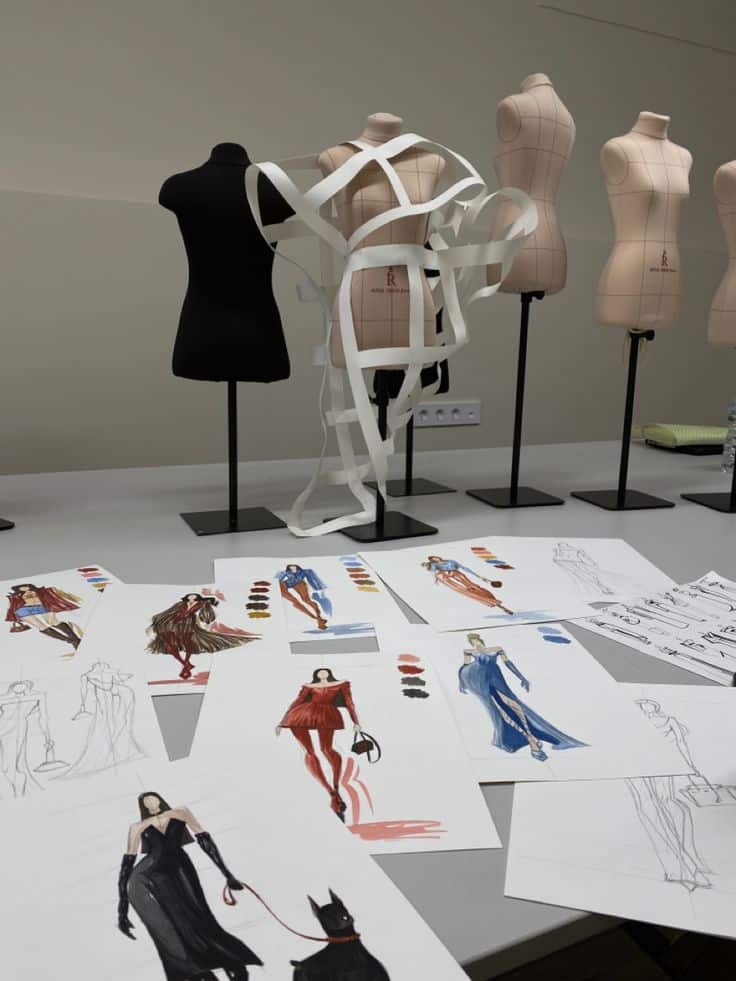 _ 9 Fashion design sketches and dress forms in a studio, showcasing creative concepts with vibrant colors and innovative garment ideas. | Sky Rye Design Fashion design sketches and dress forms in a studio, showcasing creative concepts with vibrant colors and innovative garment ideas.