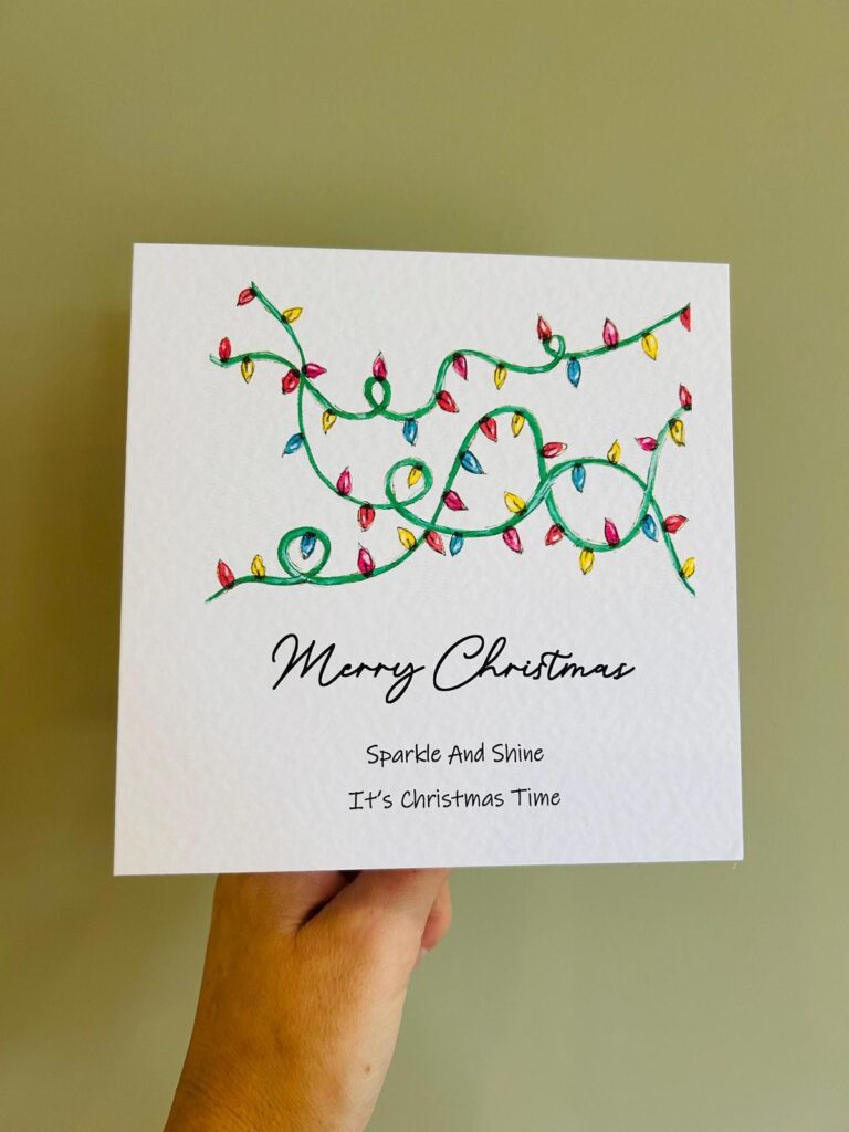 9d93b27ee0b289efbc2cb2d54e04ee66 Hand holding a festive Christmas card decorated with colorful lights, featuring the text Merry Christmas, Sparkle And Shine, It's Christmas Time. | Sky Rye Design Hand holding a festive Christmas card decorated with colorful lights, featuring the text Merry Christmas, Sparkle And Shine, It's Christmas Time.