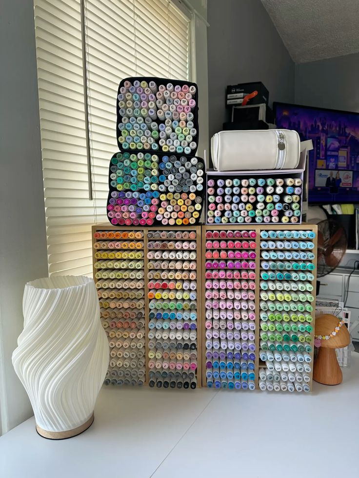 Alcohol markers for coloring Organized colored marker collection displayed on shelves by a window, with a white vase and a small lamp nearby. | Sky Rye Design Organized colored marker collection displayed on shelves by a window, with a white vase and a small lamp nearby.