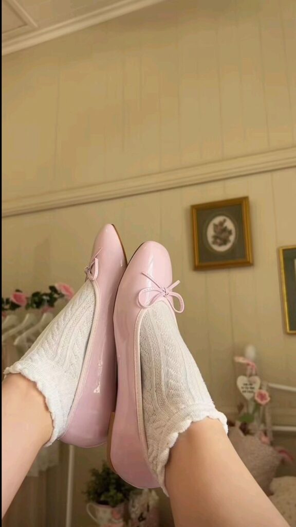 Ballet Flats 2 Pink ballet flats with bows and white lace socks in a cozy room setting. Vintage decor accents on the walls. | Sky Rye Design Pink ballet flats with bows and white lace socks in a cozy room setting. Vintage decor accents on the walls.