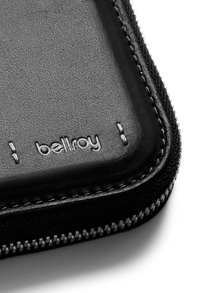 Close-up of a Bellroy leather wallet corner, highlighting its stitching and zipper detail for premium craftsmanship.