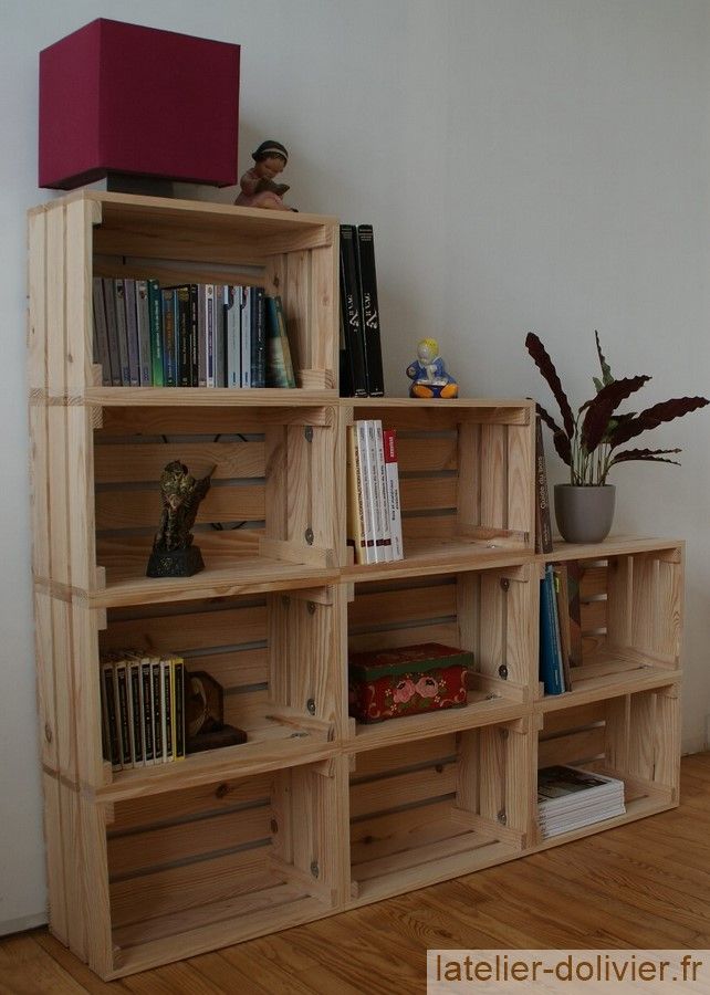 Bibliothèque _ étagère avec des caisses en bois_ DIY wooden crate bookshelf with books, decor, and a potted plant on a wooden floor. | Sky Rye Design DIY wooden crate bookshelf with books, decor, and a potted plant on a wooden floor.