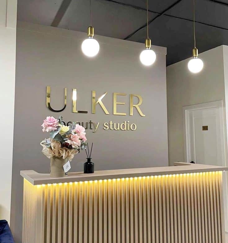 Business Sign for Wall - Custom Lobby Sign - Beauty Salon Sign - Adhesive Letters - Spa Logo Sign- Laser Cut Sign- Metal Coated Acrylic Sign Elegant Ulker Beauty Studio reception area with floral decor, modern lighting, and minimalist design. | Sky Rye Design Elegant Ulker Beauty Studio reception area with floral decor, modern lighting, and minimalist design.