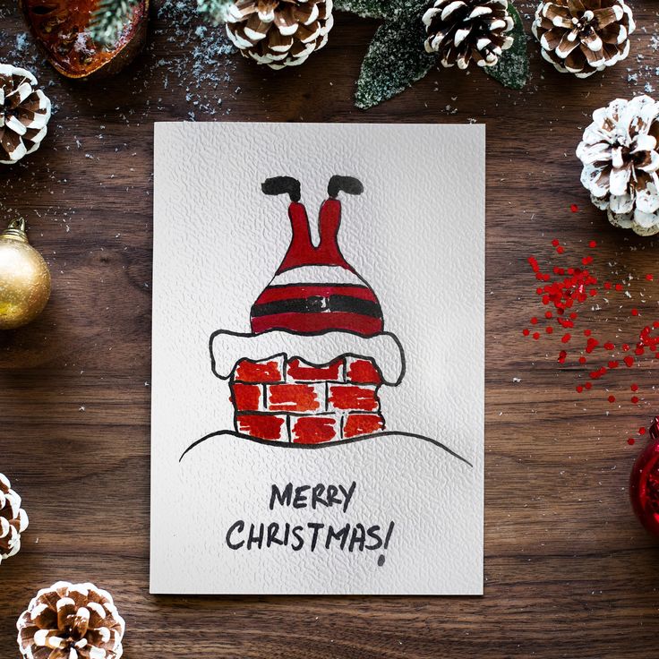 Carte de Noël Père Noël aquarelle faite main - Etsy France Festive Christmas card featuring a drawing of Santa stuck in a chimney, surrounded by pine cones and ornaments. | Sky Rye Design Festive Christmas card featuring a drawing of Santa stuck in a chimney, surrounded by pine cones and ornaments.