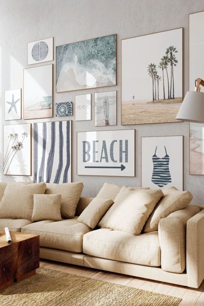Cozy living room with beige sofa and beach-themed gallery wall featuring ocean, palm tree, and coastal art prints.