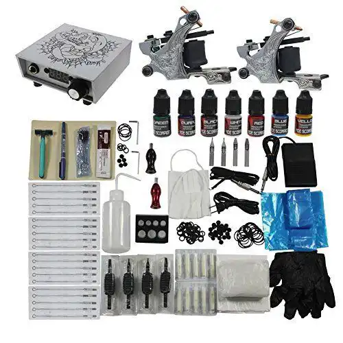 Tattoo kit with ink bottles, tattoo machines, needles, power supply, and accessories for professional tattoo artists and enthusiasts.