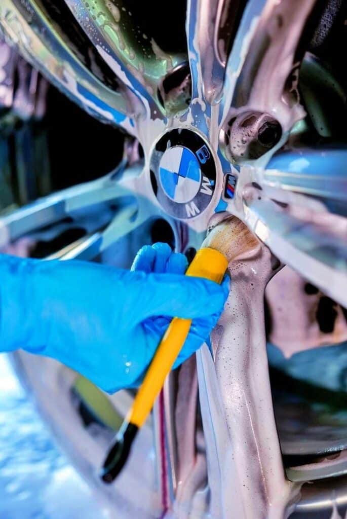 Detailing Brush Classic _ WORK STUFF Gloved hand cleaning a BMW wheel with a brush and soap, highlighting car detailing and maintenance for enhanced performance and shine. | Sky Rye Design Gloved hand cleaning a BMW wheel with a brush and soap, highlighting car detailing and maintenance for enhanced performance and shine.