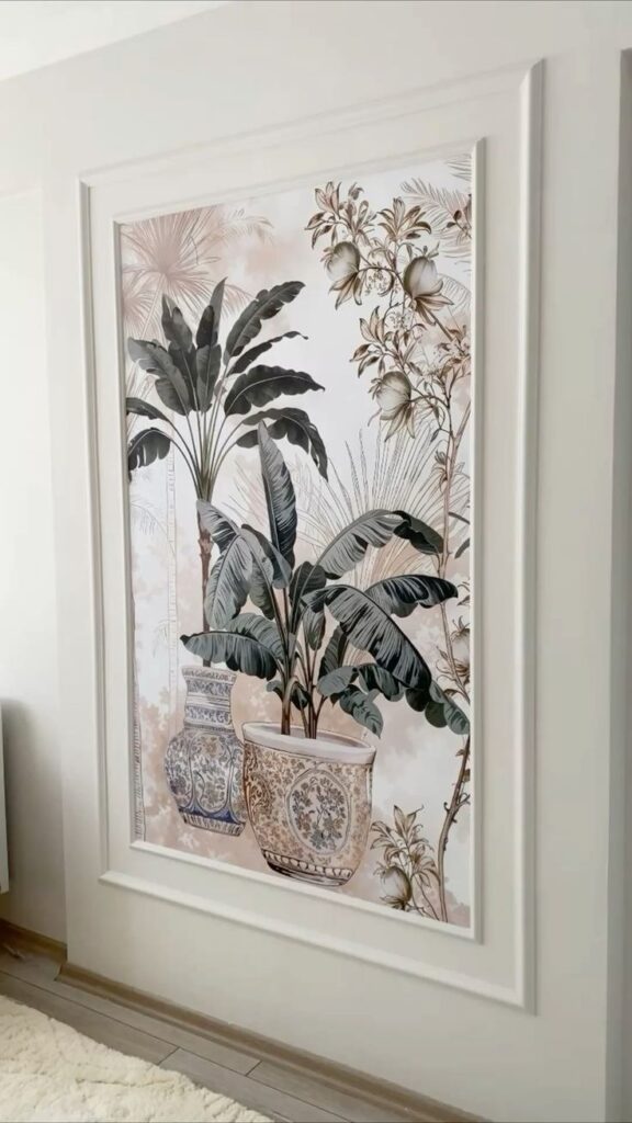 Decorative wall art featuring potted banana plants and intricate floral patterns in a white frame, adding elegance to the interior.