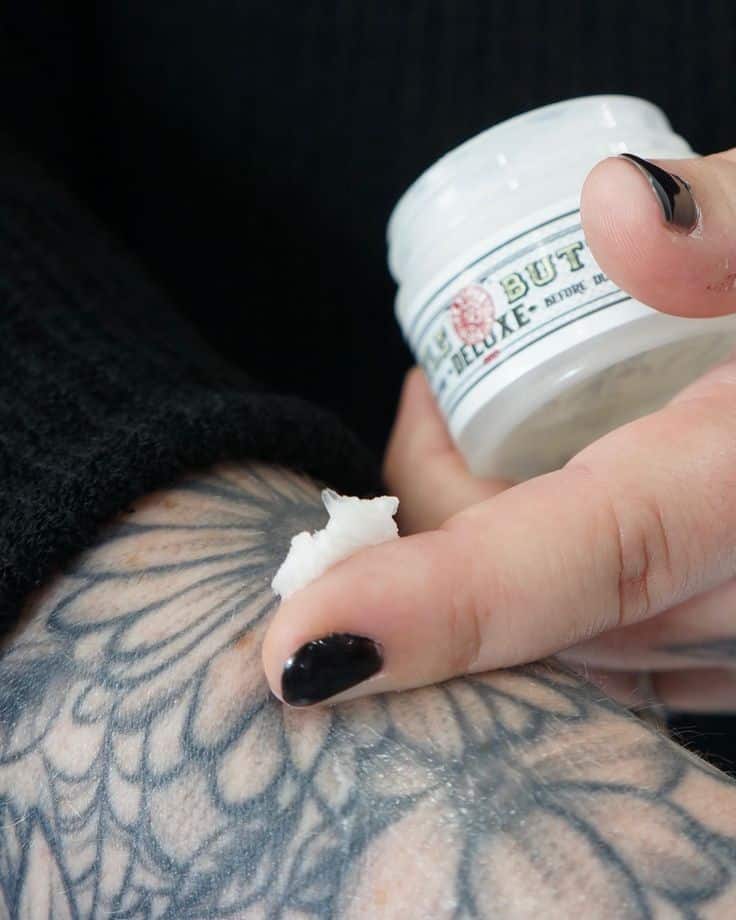 H U S T L E B U T T E R heals fresh tattoos _ prevents fading _ revives color _ nourishes skin Are you using this amazing product yet___ Applying healing balm to a tattooed arm for aftercare, promoting skin hydration and tattoo vibrancy. | Sky Rye Design Applying healing balm to a tattooed arm for aftercare, promoting skin hydration and tattoo vibrancy.