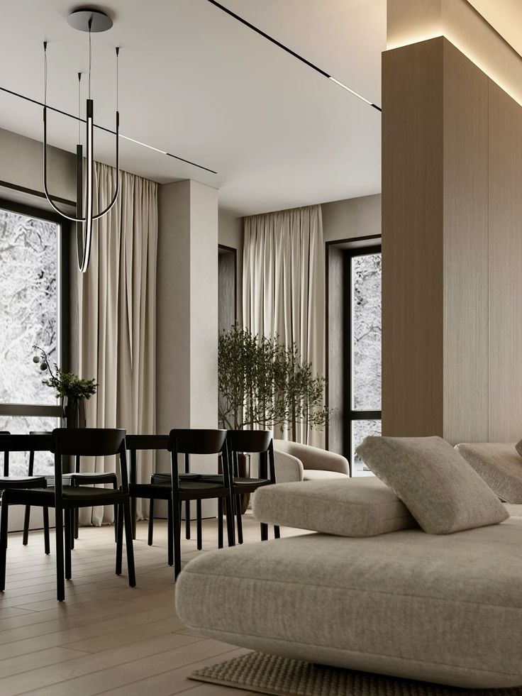 Modern living room featuring minimalist design, neutral tones, large windows, and chic furnishings. Cozy and stylish interior decor.