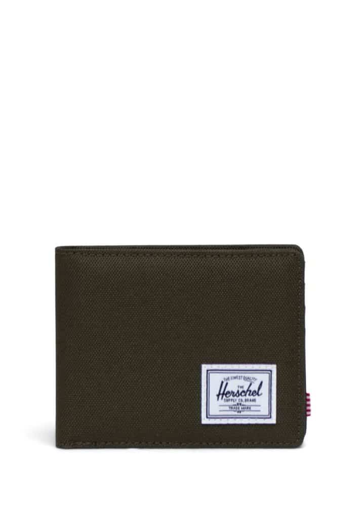 Green Herschel wallet with logo patch, perfect for organizing cards and cash. Durable and stylish accessory for everyday use.