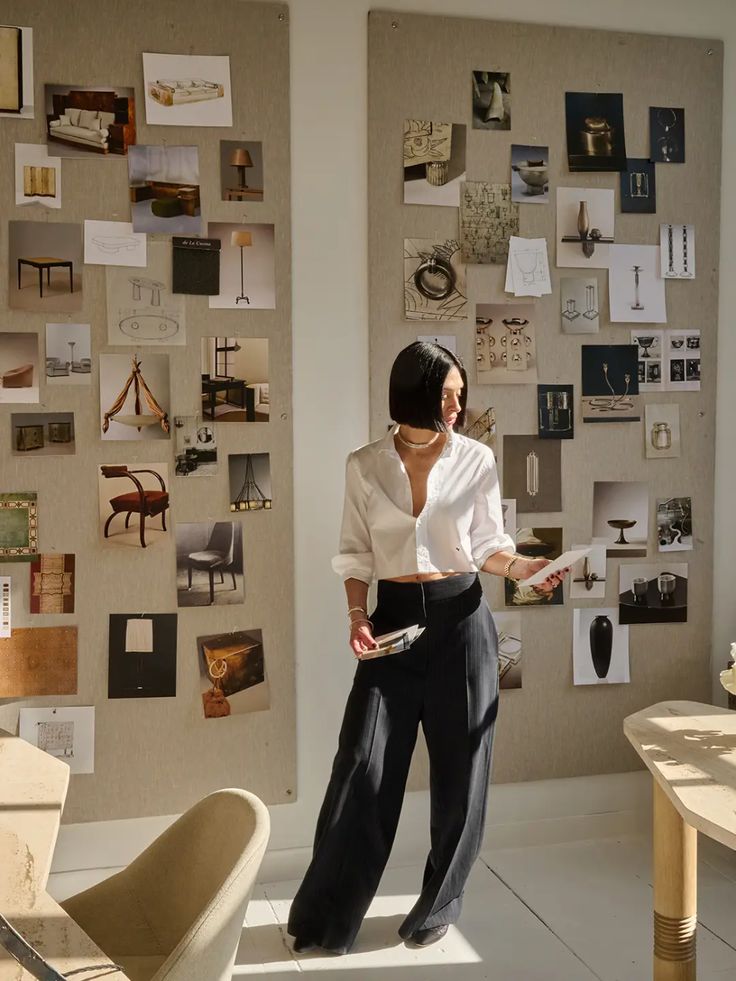 How Athena Calderone Managed to Make a Bare Industrial Warehouse Feel Homey Designer reviews mood boards in sunlit studio, featuring interior decor and inspiration images. | Sky Rye Design Designer reviews mood boards in sunlit studio, featuring interior decor and inspiration images.