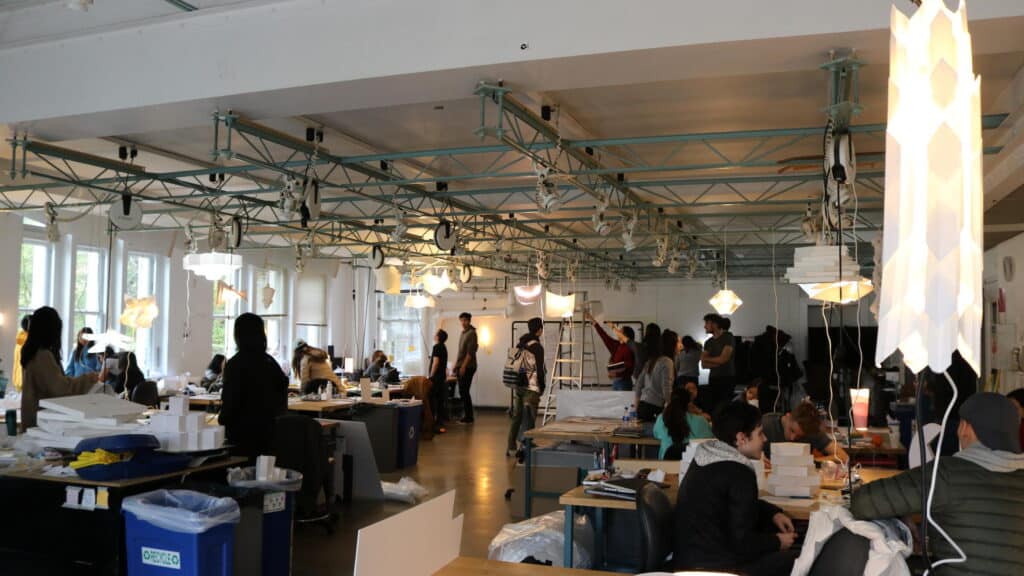 IMG_2405JPG Bustling design studio with people collaborating, working on projects under creative lighting, modern interior, engaged in teamwork. | Sky Rye Design Bustling design studio with people collaborating, working on projects under creative lighting, modern interior, engaged in teamwork.