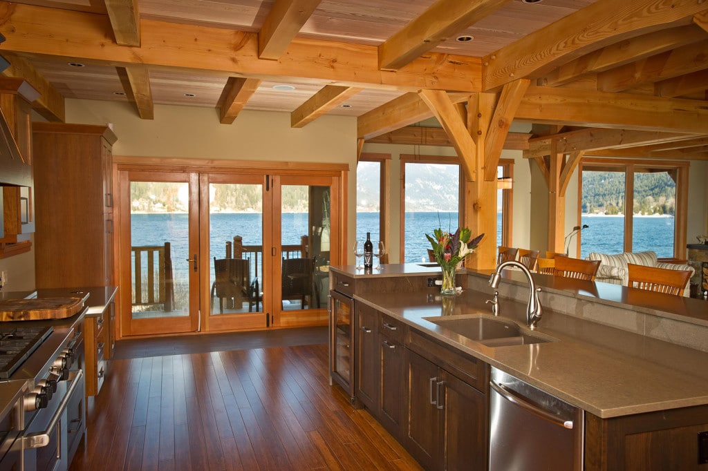 JohnsWalk1-1024x682 Spacious lakeside kitchen with wooden beams, modern appliances, and scenic water views through large glass doors. Cozy and inviting. | Sky Rye Design Spacious lakeside kitchen with wooden beams, modern appliances, and scenic water views through large glass doors. Cozy and inviting.