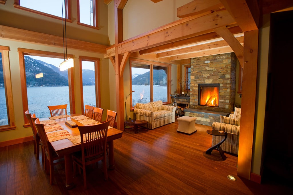 JohnsWalk6-1024x682 Cozy dining and living area with a stone fireplace, wooden beams, lake and mountain view through large windows. | Sky Rye Design Cozy dining and living area with a stone fireplace, wooden beams, lake and mountain view through large windows.