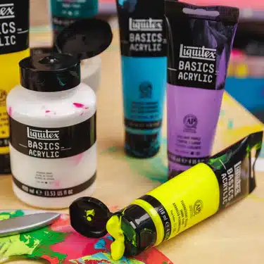 LQX_BASICS_CYE_BASICS_ACRYLIC_LIFESTYLE_375x375_crop_center Assorted Liquitex Basics acrylic paints in vibrant colors on a table, ready for creative art projects. | Sky Rye Design Assorted Liquitex Basics acrylic paints in vibrant colors on a table, ready for creative art projects.