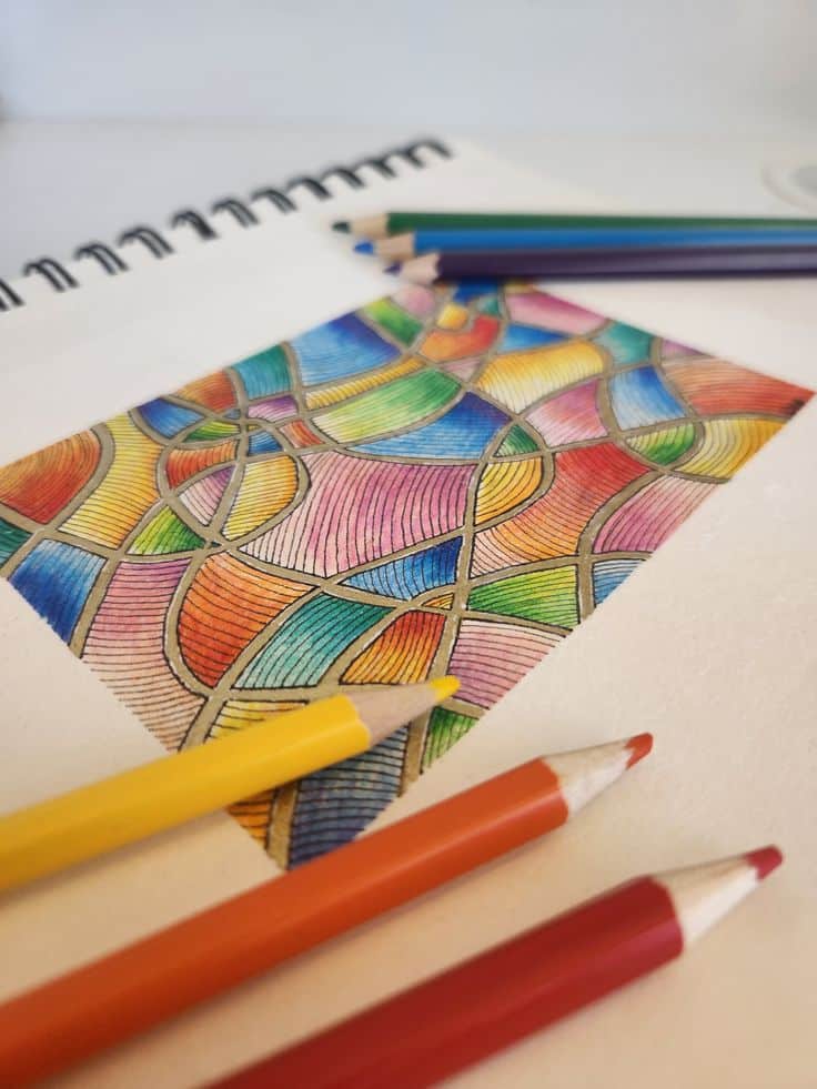 Lifes a Journey Colorful abstract drawing on notepad with colored pencils nearby, showcasing intricate geometric patterns and vibrant hues. | Sky Rye Design Colorful abstract drawing on notepad with colored pencils nearby, showcasing intricate geometric patterns and vibrant hues.