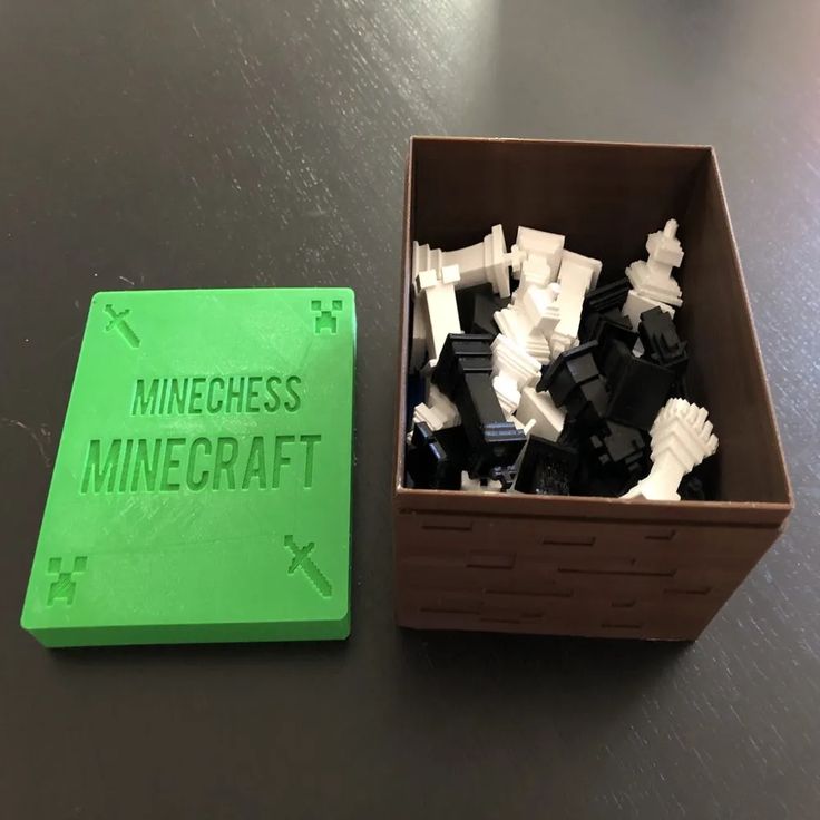 Minechess minecraft remix - Free 3D Print Model - MakerWorld MineChess box with Minecraft chess pieces, featuring a green cover labeled 'MINECHESS MINECRAFT' and a box full of black and white pieces. | Sky Rye Design MineChess box with Minecraft chess pieces, featuring a green cover labeled 'MINECHESS MINECRAFT' and a box full of black and white pieces. how to 3d print minecraft