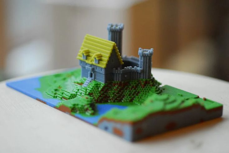 Minecraft 3D Printing Guide Pixel art-style castle diorama with towers and a yellow roof, set on a grassy landscape with a blue river. | Sky Rye Design Pixel art-style castle diorama with towers and a yellow roof, set on a grassy landscape with a blue river.
