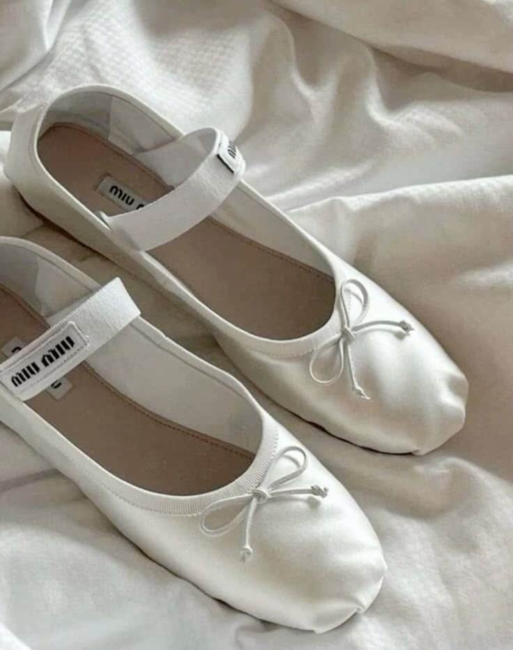 Miu Miu Ballet Flats 🩰 Elegant white ballet flats with bow detailing on a soft fabric background, perfect for casual or dressy occasions. | Sky Rye Design Elegant white ballet flats with bow detailing on a soft fabric background, perfect for casual or dressy occasions.