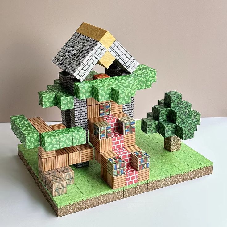 New Pixel Model Magnetic Building Blocks Cube Creative DIY Toys For Children Educational Toy Pixelated block house with a tree, featuring a grass base and a colorful roof, resembling a Minecraft-style design. | Sky Rye Design Pixelated block house with a tree, featuring a grass base and a colorful roof, resembling a Minecraft-style design.
