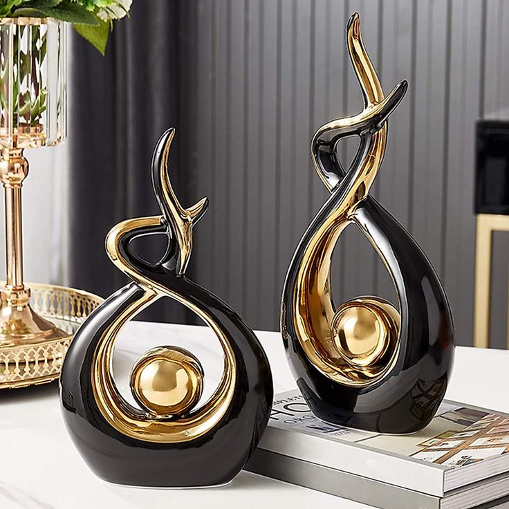 Pearlead Creative Ceramic Sculpture Abstract Ornament Figurine Gold Modern Statue for Home Office Decor Centerpiece Decoration Living Room 12_2 Inches Black Elegant black and gold abstract sculptures on a table, perfect for modern home decor and artistic interior design inspiration. | Sky Rye Design Elegant black and gold abstract sculptures on a table, perfect for modern home decor and artistic interior design inspiration.
