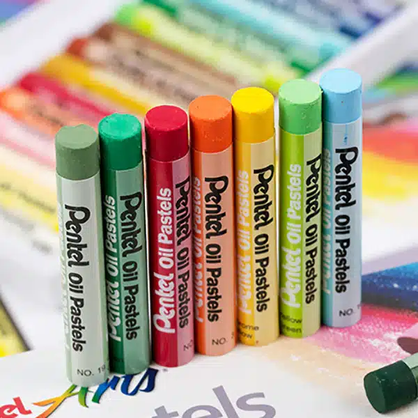 Pentel-Washable-Oil-Pastel-25-36-50-Colors-Set-9 Colorful Pentel oil pastels arranged upright, showcasing vibrant shades for art and creativity on a stained paper background. | Sky Rye Design Colorful Pentel oil pastels arranged upright, showcasing vibrant shades for art and creativity on a stained paper background.