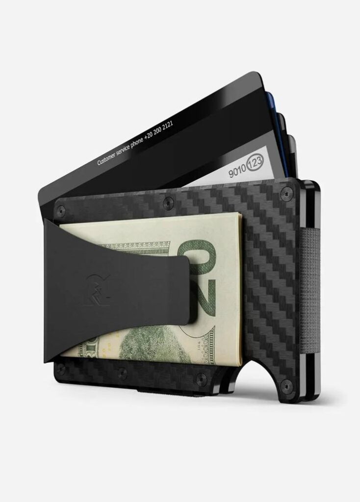 Slim carbon fiber wallet with cash clip, holding credit cards and folded bills, ideal for modern, minimalist lifestyle.