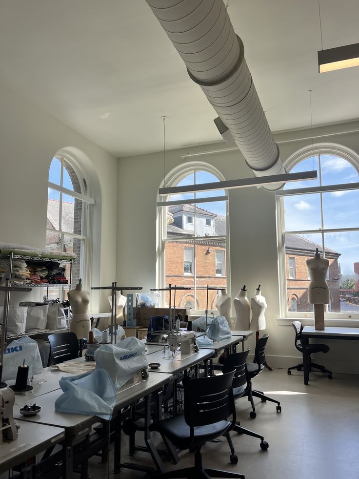 Studio 🤍 Bright sewing studio with mannequins, sewing machines, and large windows. Natural light enhances creative workspace ambiance. | Sky Rye Design Bright sewing studio with mannequins, sewing machines, and large windows. Natural light enhances creative workspace ambiance.