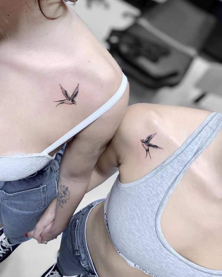 Swallow Tattoos _ Tattoofilter Matching bird tattoos on shoulders, worn by two people in casual tops and jeans, symbolizing friendship and freedom. | Sky Rye Design Matching bird tattoos on shoulders, worn by two people in casual tops and jeans, symbolizing friendship and freedom.