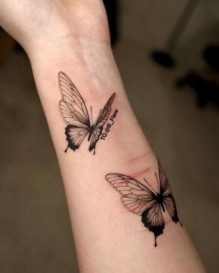 Tatoo Intricate butterfly tattoos on a forearm, showcasing delicate lines and shading in black ink, highlighting artistic tattoo design. | Sky Rye Design Intricate butterfly tattoos on a forearm, showcasing delicate lines and shading in black ink, highlighting artistic tattoo design.