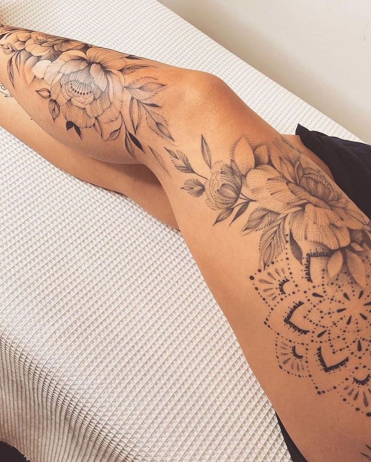 Tattoo Idea Intricate floral leg tattoo with black and grey detailing, showcasing vibrant flowers and geometric patterns on a woman's thigh and calf. | Sky Rye Design Intricate floral leg tattoo with black and grey detailing, showcasing vibrant flowers and geometric patterns on a woman's thigh and calf.