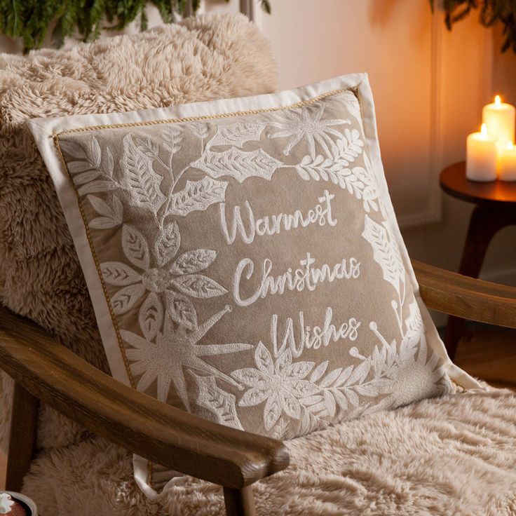 Winter Warmest Wishes Embroidered Cushion Natural - Natural _ 50 x 50cm _ Cover Only Cozy armchair with a festive cushion embroidered with Warmest Christmas Wishes surrounded by soft lighting and holiday decor. | Sky Rye Design Cozy armchair with a festive cushion embroidered with Warmest Christmas Wishes surrounded by soft lighting and holiday decor.
