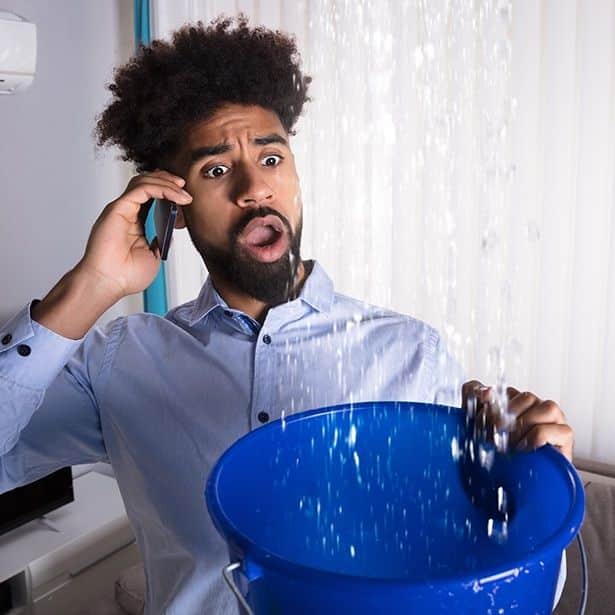 a533d4e7e41aef1f52a8c153d5df1da9 Man on phone holds bucket under leaking water from ceiling indoors, looking surprised. | Sky Rye Design Man on phone holds bucket under leaking water from ceiling indoors, looking surprised.
