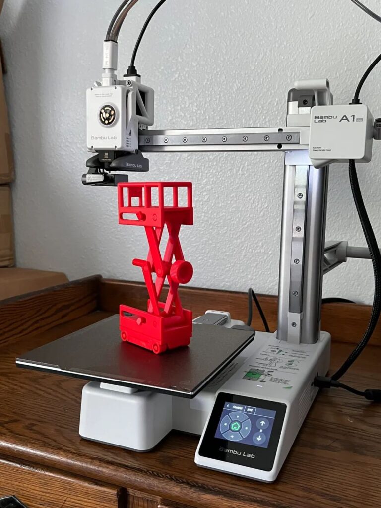 ada9af173812d12d3b11cd57c47857ec 3D printer creating a red model lift on a Bambu Lab machine, set on a wooden desk, showcasing modern technology in action. | Sky Rye Design 3D printer creating a red model lift on a Bambu Lab machine, set on a wooden desk, showcasing modern technology in action.