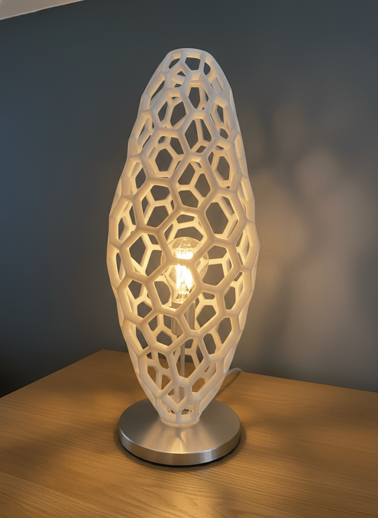 ai-photo-studio-1765922138232-1 Futuristic lamp with geometric lattice design on wooden table, providing warm ambient lighting against dark wall background. | Sky Rye Design Futuristic lamp with geometric lattice design on wooden table, providing warm ambient lighting against dark wall background.