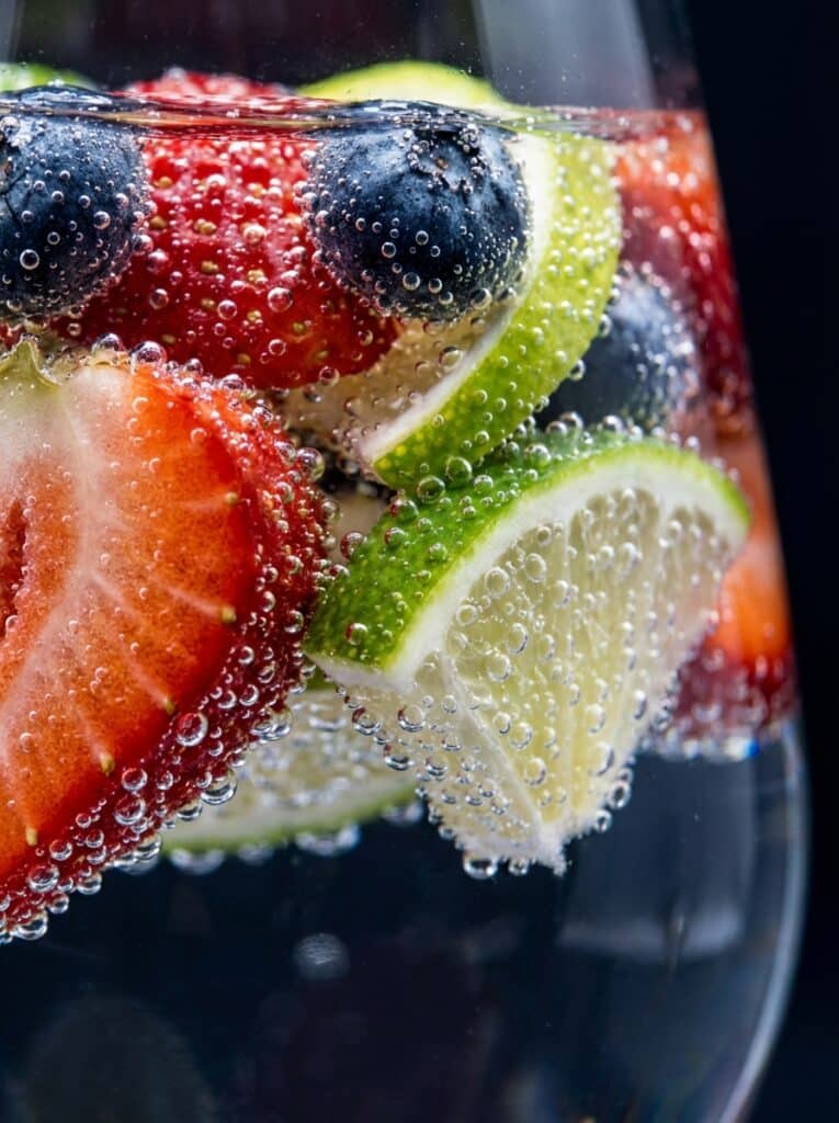 ai-photo-studio-1766360865505-1 Fresh berries and lime slices in sparkling water, highlighting refreshing, healthy flavors and vibrant colors perfect for a summer drink. | Sky Rye Design Fresh berries and lime slices in sparkling water, highlighting refreshing, healthy flavors and vibrant colors perfect for a summer drink.