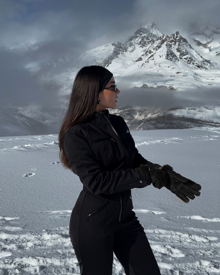 arrived in winterwonderland guess ❄️ I werbung __GUESSWinter guess Woman in black winter attire against a snowy mountain backdrop, wearing sunglasses and gloves on a cold, overcast day. | Sky Rye Design Woman in black winter attire against a snowy mountain backdrop, wearing sunglasses and gloves on a cold, overcast day.