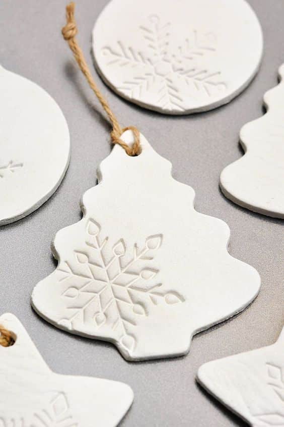 b5e0548c4ce73659950aa7b33aa2e514 White clay Christmas ornaments with snowflake patterns on a gray background, featuring tree and round shapes for festive decoration. | Sky Rye Design White clay Christmas ornaments with snowflake patterns on a gray background, featuring tree and round shapes for festive decoration.