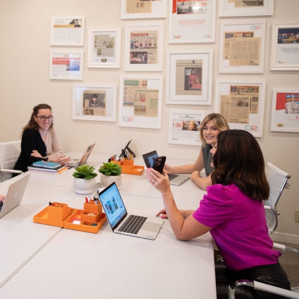 c043acddd450191d0a0c8b2600ef010d Team collaborating in a modern office with laptops and framed articles. Engaged discussion in a creative workspace. | Sky Rye Design Team collaborating in a modern office with laptops and framed articles. Engaged discussion in a creative workspace.