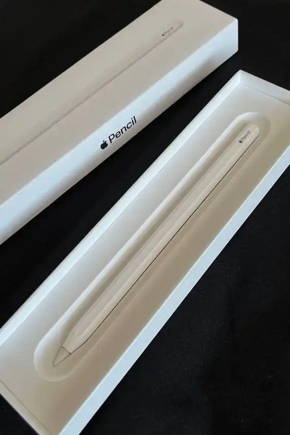 Apple Pencil in box on black background, ready for use with iPad. Enhance creativity and precision drawing with this sleek, innovative stylus.