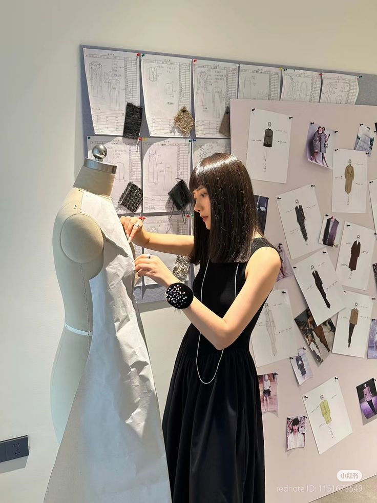 d18531a5-53ba-49b9-ba11-bfae2f8a76a2 Fashion designer draping fabric on a mannequin in a studio with sketches and fabric samples on the wall. Creativity in fashion design. | Sky Rye Design Fashion designer draping fabric on a mannequin in a studio with sketches and fabric samples on the wall. Creativity in fashion design.