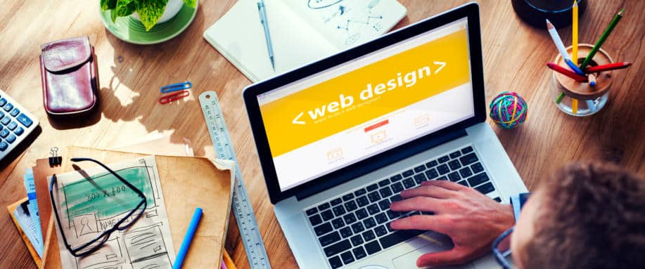 developing-website-design-strategy-branding Person working on a laptop with a web design screen, surrounded by design tools, plants, and sketches on a wooden desk. | Sky Rye Design Person working on a laptop with a web design screen, surrounded by design tools, plants, and sketches on a wooden desk.