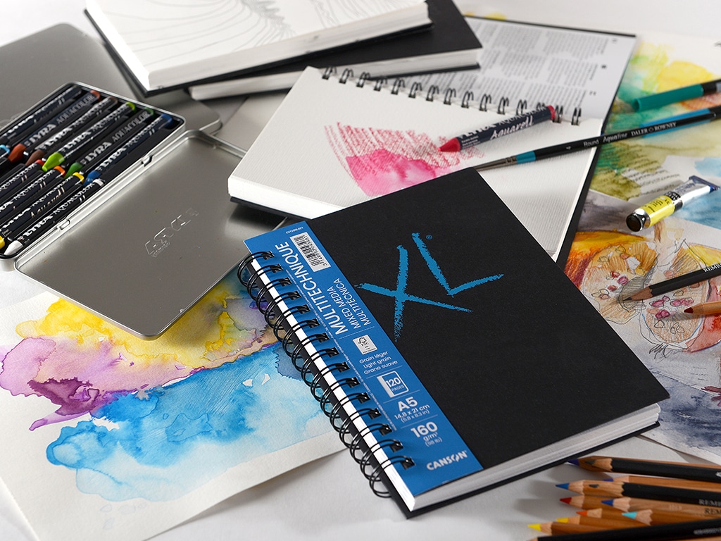 extra_15768 Art supplies and sketchbooks with colorful drawings and pencils on a desk, showcasing creativity and artistic tools. | Sky Rye Design Art supplies and sketchbooks with colorful drawings and pencils on a desk, showcasing creativity and artistic tools.