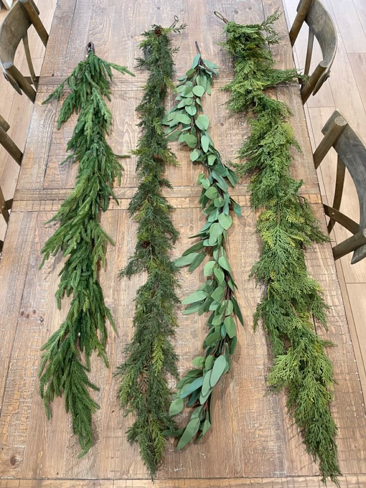 f5f3c8d0e39221c61e4005e662e91e45 Variety of green garlands on a wooden table, showcasing different textures and shades for festive decoration and home decor inspiration. | Sky Rye Design Variety of green garlands on a wooden table, showcasing different textures and shades for festive decoration and home decor inspiration.