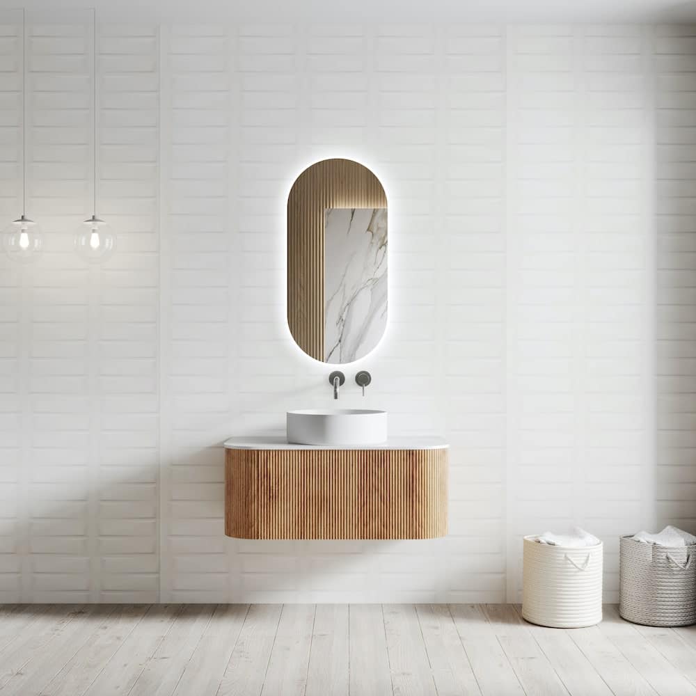 fluted-solid-wood-vanity-with-led-mirror-large-min1593078301xl_885257369_xl Modern minimalist bathroom with wooden vanity, oval mirror, and soft lighting. Two storage baskets sit on a light wood floor. | Sky Rye Design Modern minimalist bathroom with wooden vanity, oval mirror, and soft lighting. Two storage baskets sit on a light wood floor.