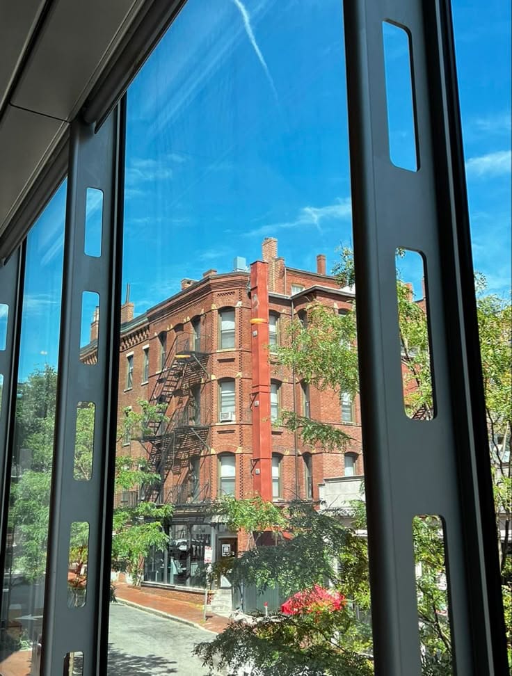 harvard campus ♫₊˚_🎧 ✩ View of a historic red brick building with fire escape through large windows, under a clear blue sky. Urban architecture scene. | Sky Rye Design View of a historic red brick building with fire escape through large windows, under a clear blue sky. Urban architecture scene.