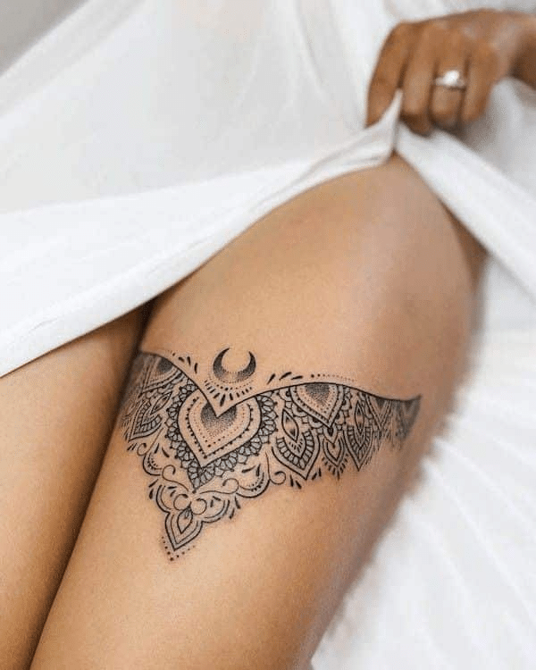 image Intricate lace thigh tattoo with mandala and crescent moon design, partially covered by a white fabric. | Sky Rye Design Intricate lace thigh tattoo with mandala and crescent moon design, partially covered by a white fabric.