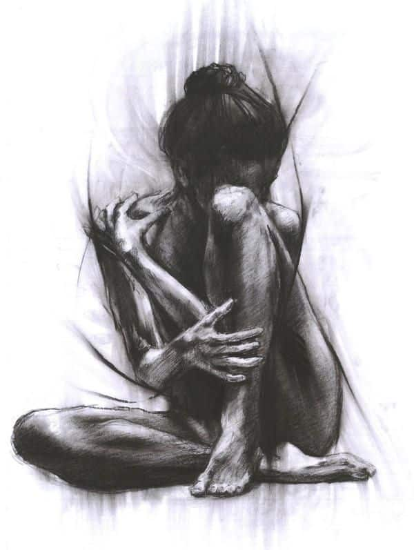 Charcoal sketch of a seated figure embracing their knees, conveying a sense of introspection and vulnerability in monochrome shades.