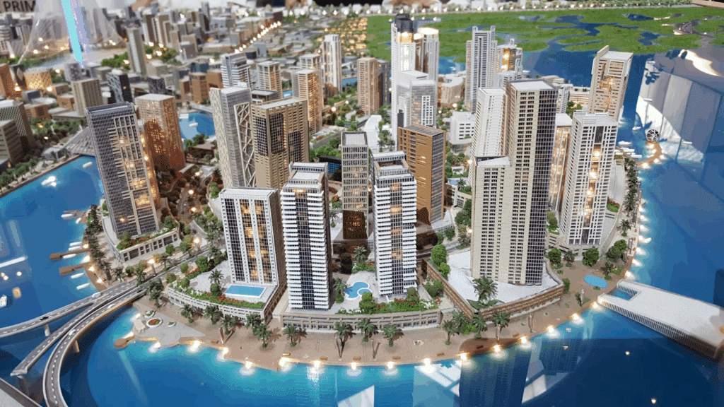 Miniature urban landscape with skyscrapers, bridges, and water features, showcasing modern city architecture and design.